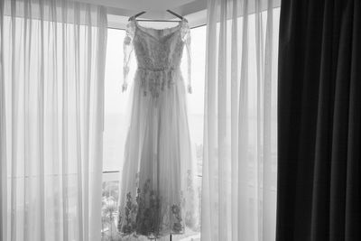 Low angle view of curtain on glass window at home