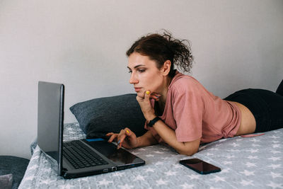 Young man using laptop at home