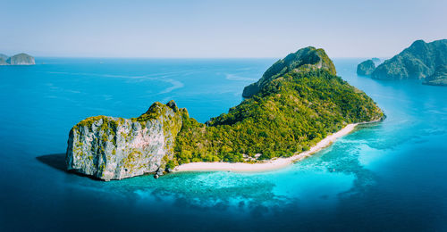 Panoramic shot of rock in sea against sky