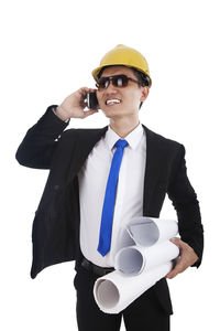 Mid adult man holding coffee cup against white background