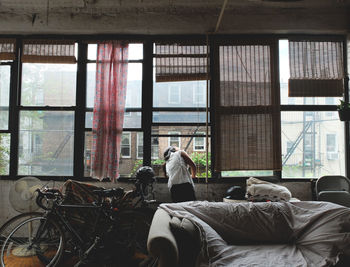 Woman looking through window