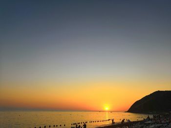 Scenic view of sea against clear sky during sunset