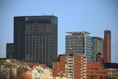 Low angle view of buildings against clear blue sky