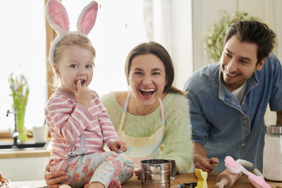 Family preparing food in kitchen