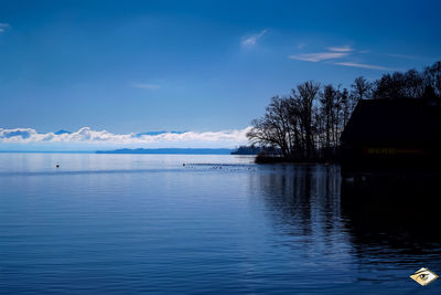 Scenic view of lake against blue sky