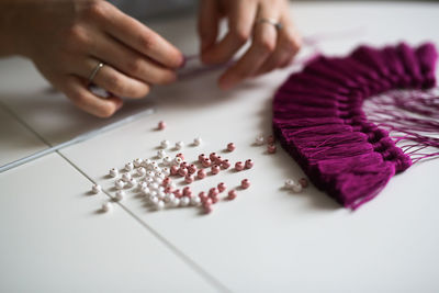 Craftswoman makes brushes from threads. concept creativity and handwork, toning in real interior