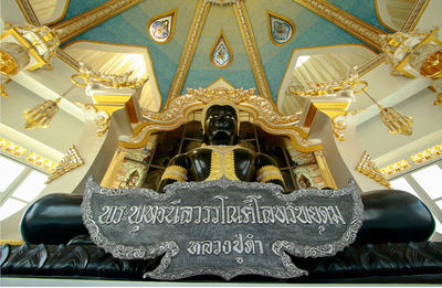 Low angle view of sculptures on ceiling in temple