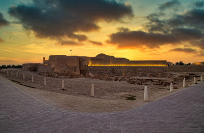 View of historic building against cloudy sky during sunset