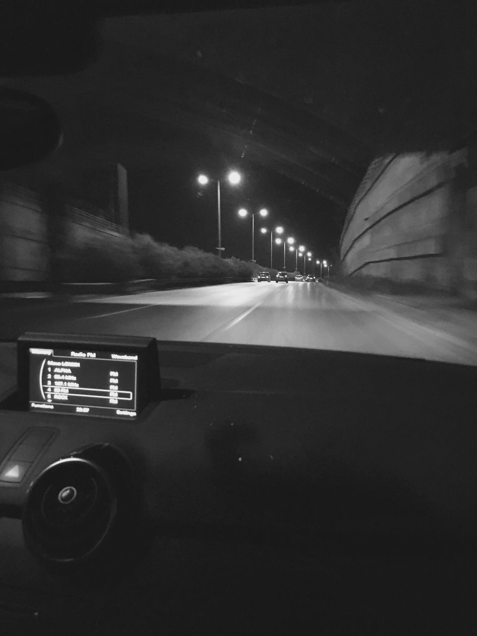 transportation, mode of transport, car, land vehicle, road, illuminated, vehicle interior, travel, car interior, road marking, night, on the move, windshield, street, indoors, communication, dashboard, no people, blurred motion, text