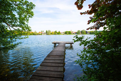 Pier over lake against sky