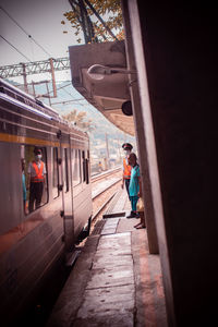 People on train at railroad station platform