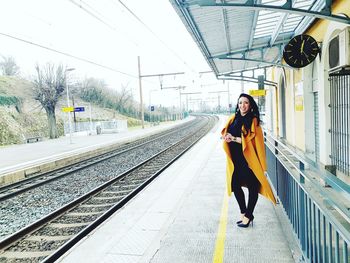 Woman standing on railroad track