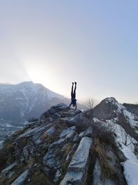 Man on snowcapped mountain against clear sky