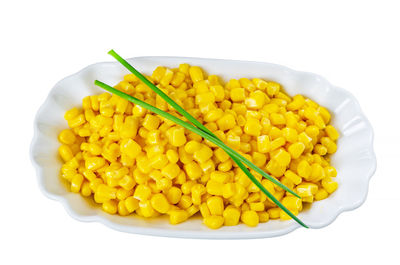 High angle view of vegetables in plate against white background