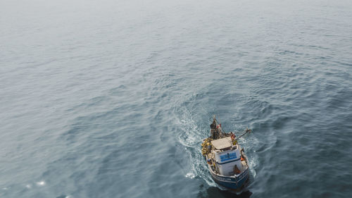 High angle view of ship sailing in sea