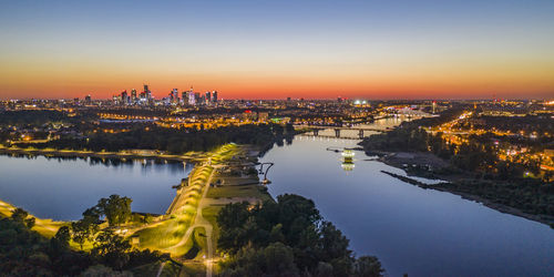 High angle view of illuminated buildings against sky during sunset