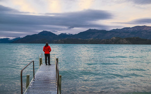 Woman standing on pier at lago rio tranquillo, carretera austral, ayse