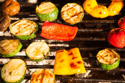 Fried vegetables on a grate on coals.