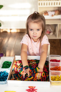 Portrait of cute girl sitting on table