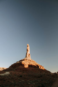 Low angle view of rock formation against clear sky