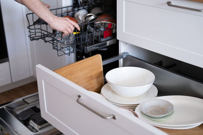 Cropped hand of woman preparing food in kitchen