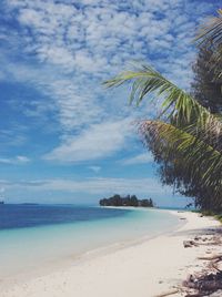 View of calm beach against blue sky