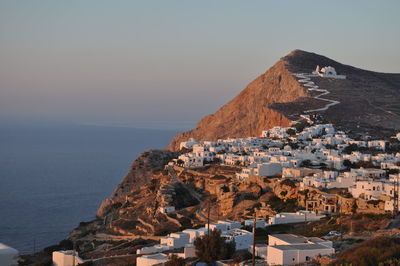 Townscape by sea against clear sky