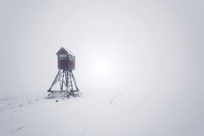 Snow covered land against sky