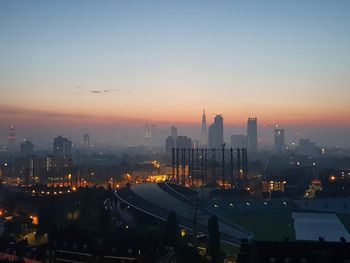 High angle view of illuminated buildings against sky at sunset