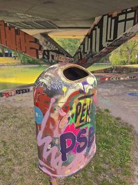 Close-up of graffiti on metal bridge