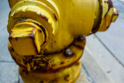 Cropped image of rusty fire hydrant on footpath