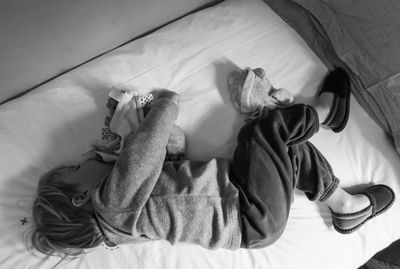 Boy sleeping on bed at home