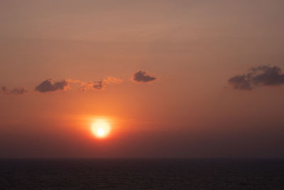 Scenic view of sea against orange sky
