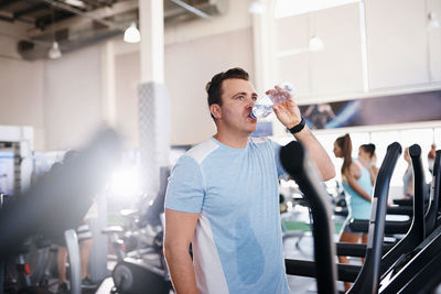 Man drinking water in gym