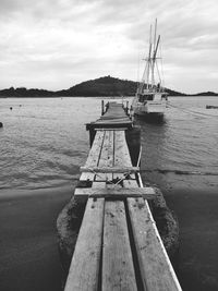 Boat moored on sea against sky