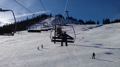 Ski lift over snow covered landscape