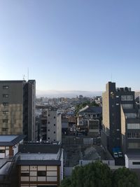 High angle view of buildings against clear blue sky