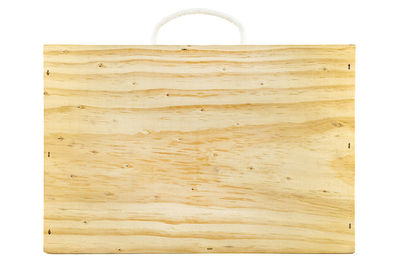 Close-up of old wooden table against white background