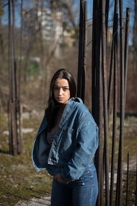 Young woman standing in forest
