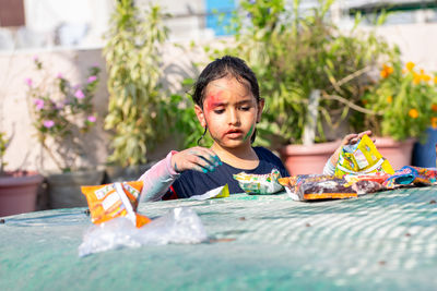 Little girl picking colors to play holi