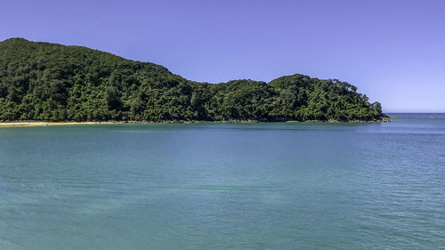 Scenic view of sea against clear blue sky