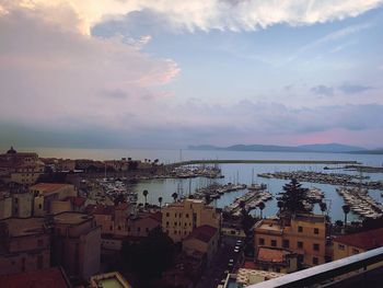 High angle view of city by sea against sky