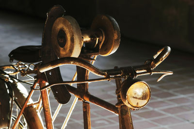 Close-up of bicycle parked on footpath