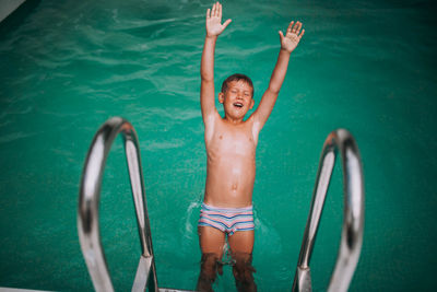 Full length of shirtless boy in swimming pool