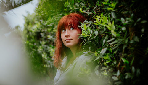 Red head girl, portrait in green forest, caucasian people lifestyle.