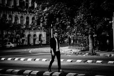 Rear view of man walking on street in city