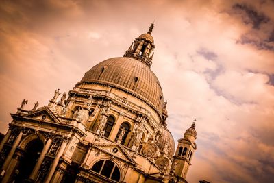 Low angle view of statue of temple against cloudy sky
