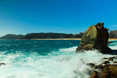 Scenic view of sea against clear blue sky