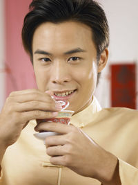 Man holding drink while at home during festival