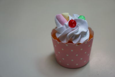 Close-up of cupcakes fancy on table against white background